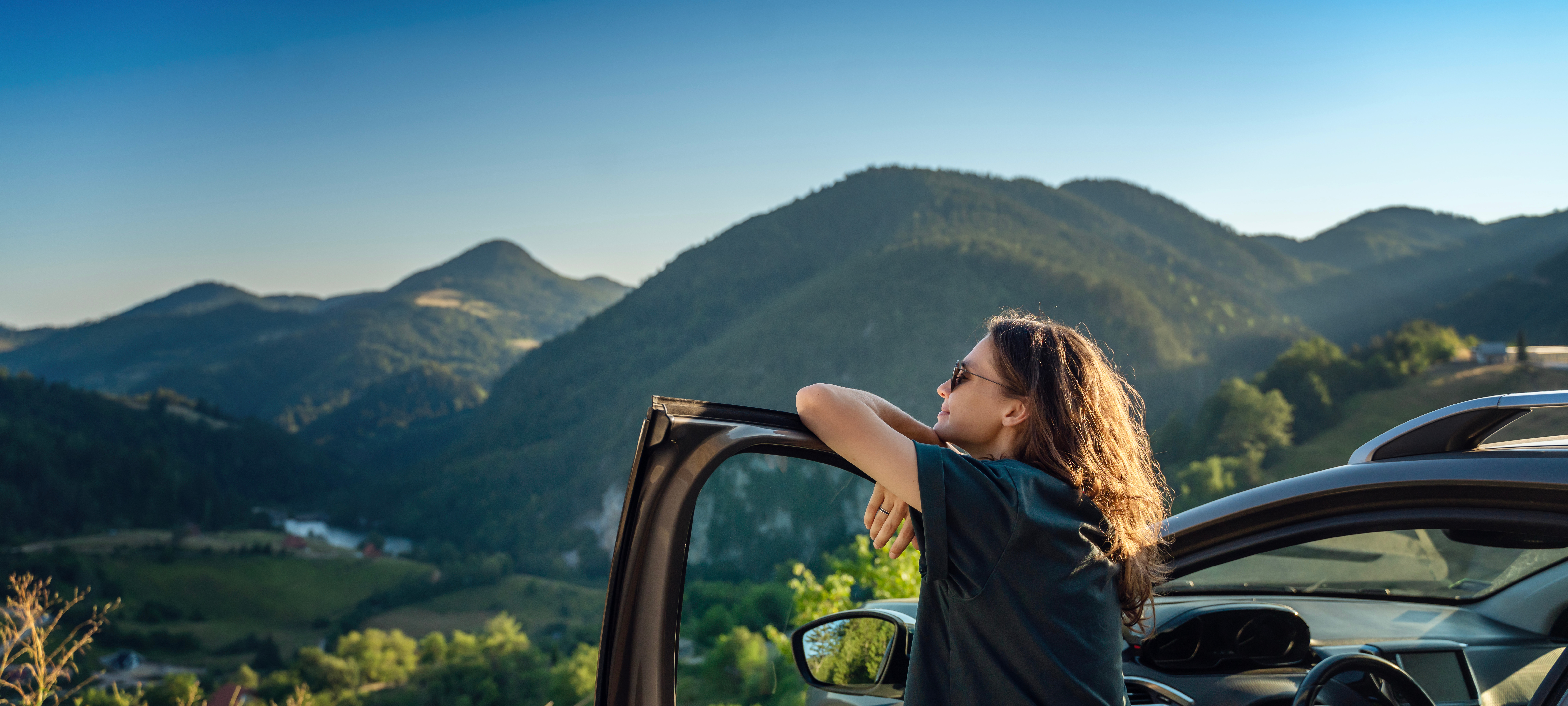 A woman looking out over a mountain valley